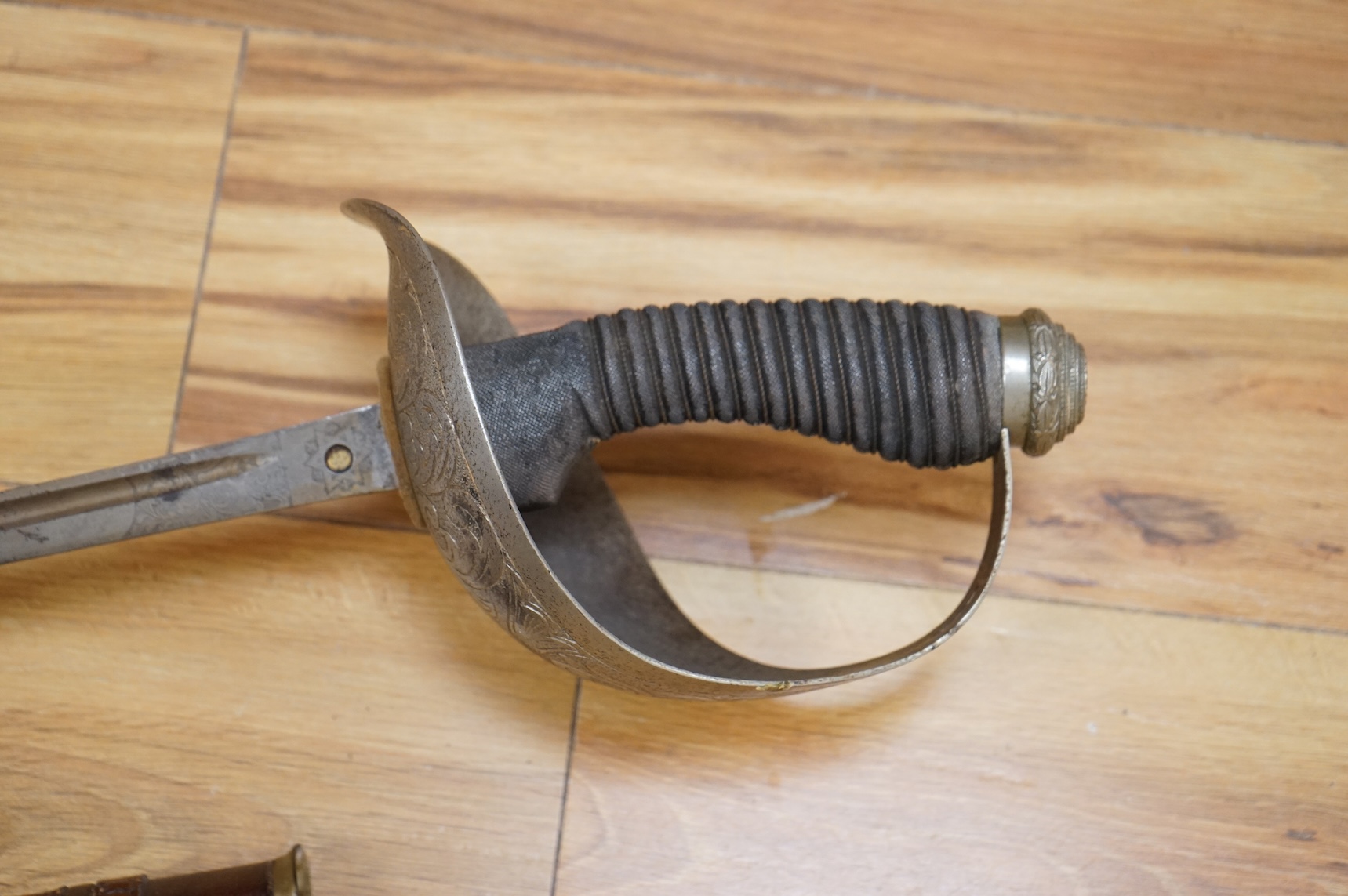 A 1911 pattern cavalry officer’s sword by J. Gaunt and son, etched with crowned GVR cipher and owner’s initials; HPH, regulation hilt and leather covered scabbard